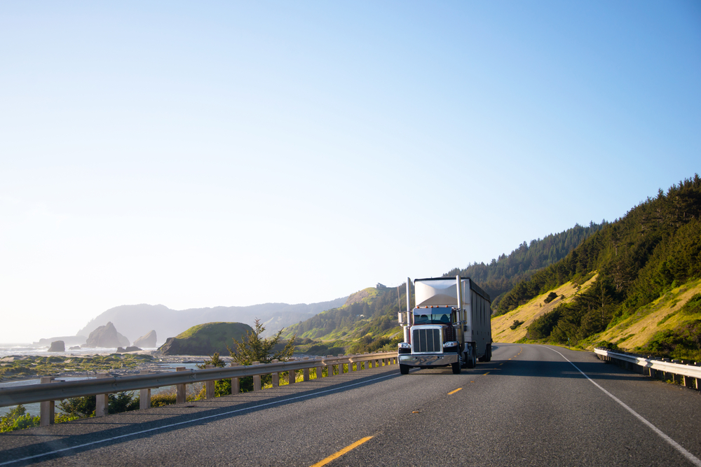Truck driving down a road