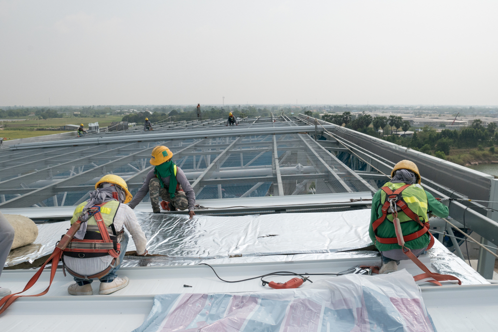 Construction workers working on top of a building