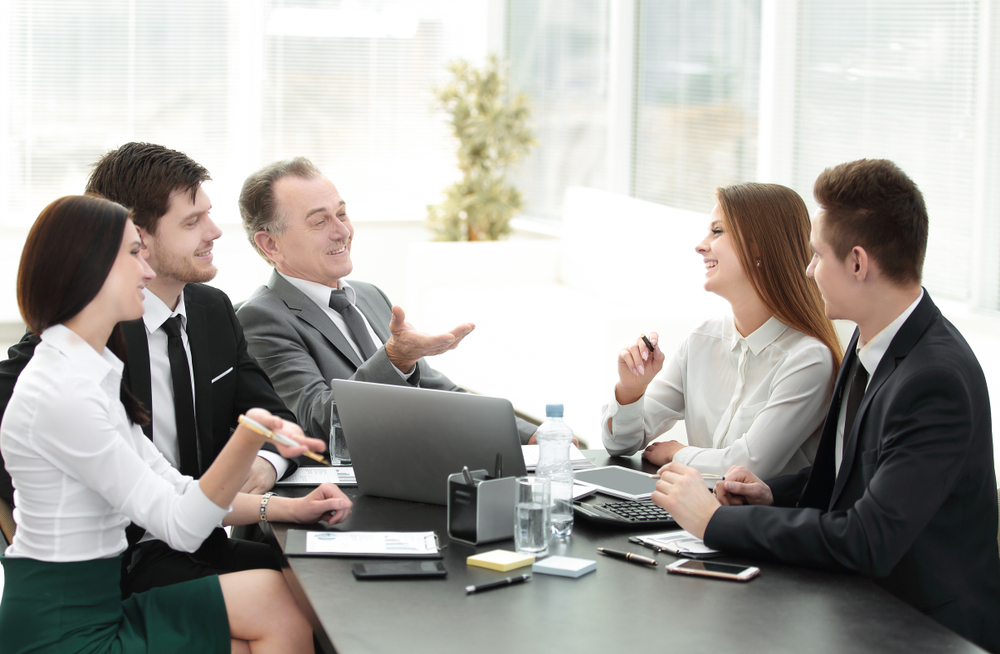 Group of business people talking at a table